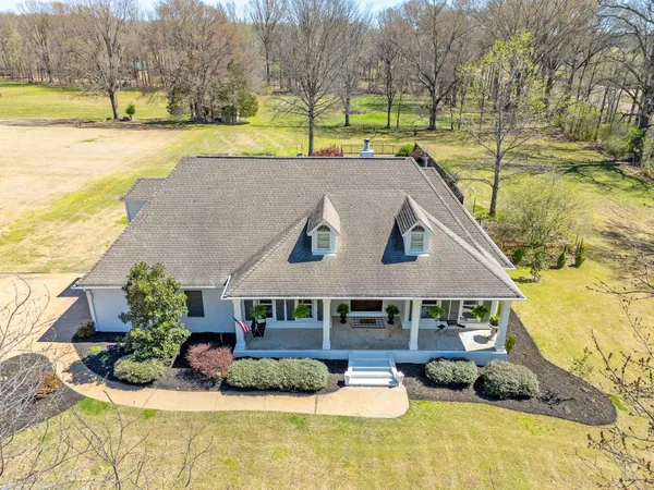 a view of a house with pool and a yard