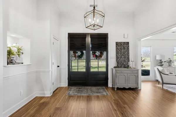 a view of a hardwood floor and a kitchen