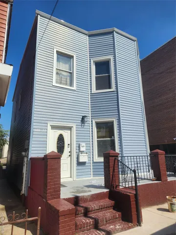a view of a house with more windows and wooden fence