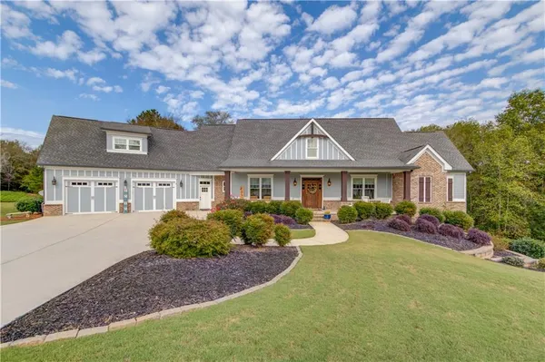a front view of a house with yard porch and sitting area