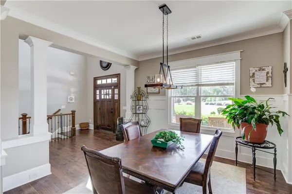 a view of a dining room with furniture window and wooden floor