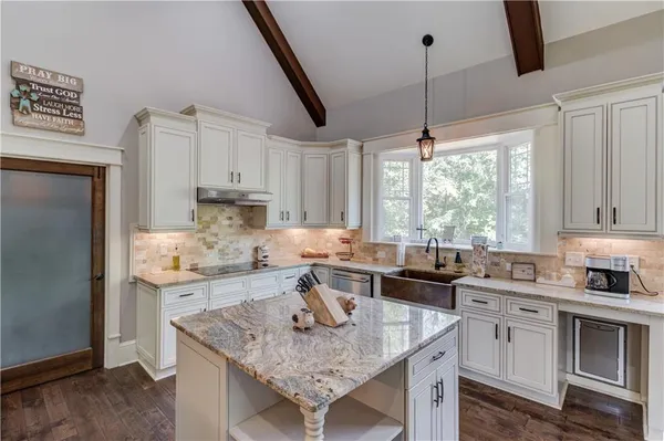 a bathroom with a granite countertop sink mirror and a bathtub