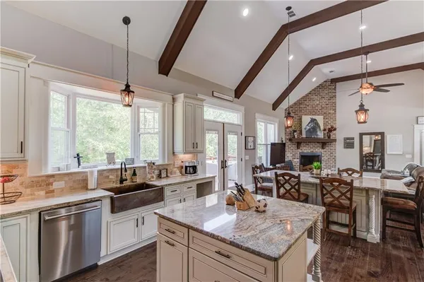 a kitchen with stainless steel appliances granite countertop a refrigerator and a sink
