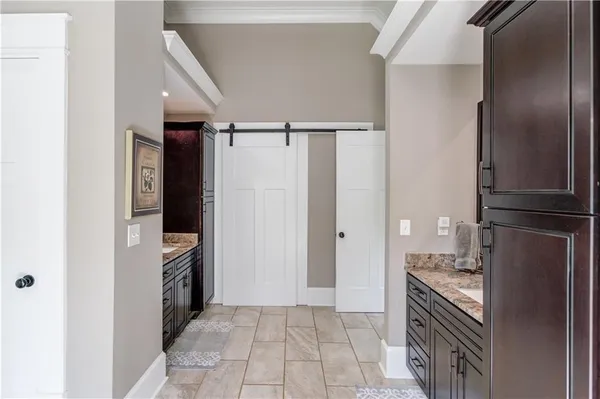 a bathroom with a granite countertop sink mirror vanity and toilet