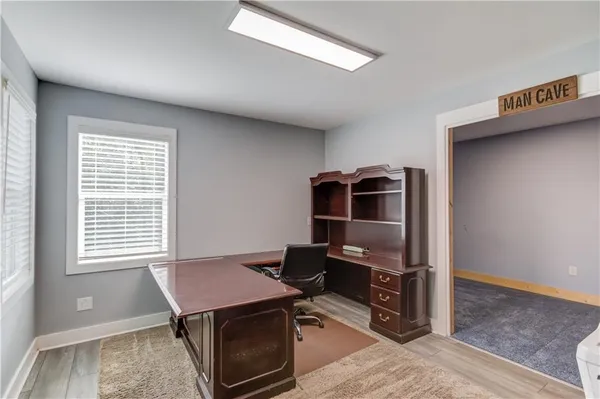 a view of a roof deck with large trees and wooden fence