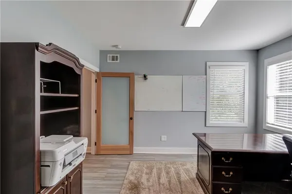 a view of a house with wooden deck and a yard