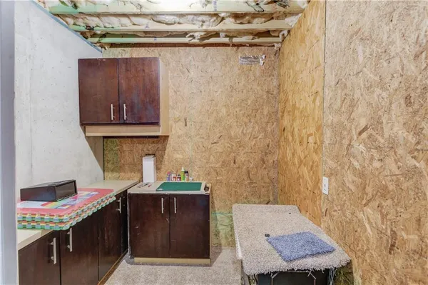 a view of a wooden deck and lake with trees in the background