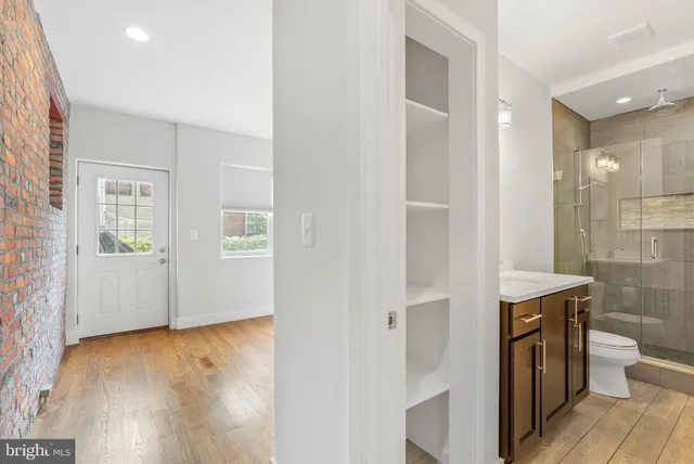 a bathroom with a sink toilet a mirror and shower