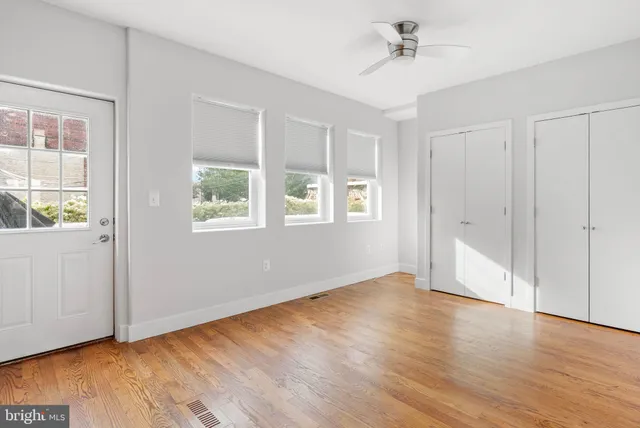 a view of an empty room and wooden floor