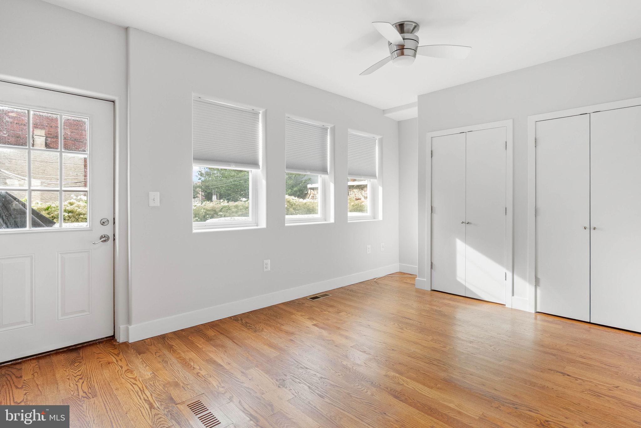 924 South 11th Street, Unit 101 Philadelphia, PA 19147 - Photo 16 of 27 a view of an empty room with wooden floor and a window