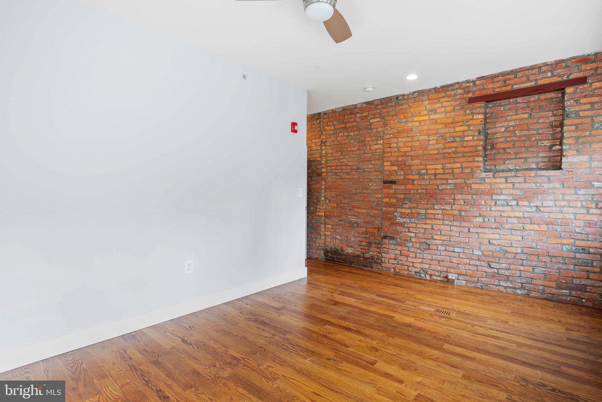 924 South 11th Street, Unit 101 Philadelphia, PA 19147 - Photo 17 of 27 a view of an empty room and wooden floor