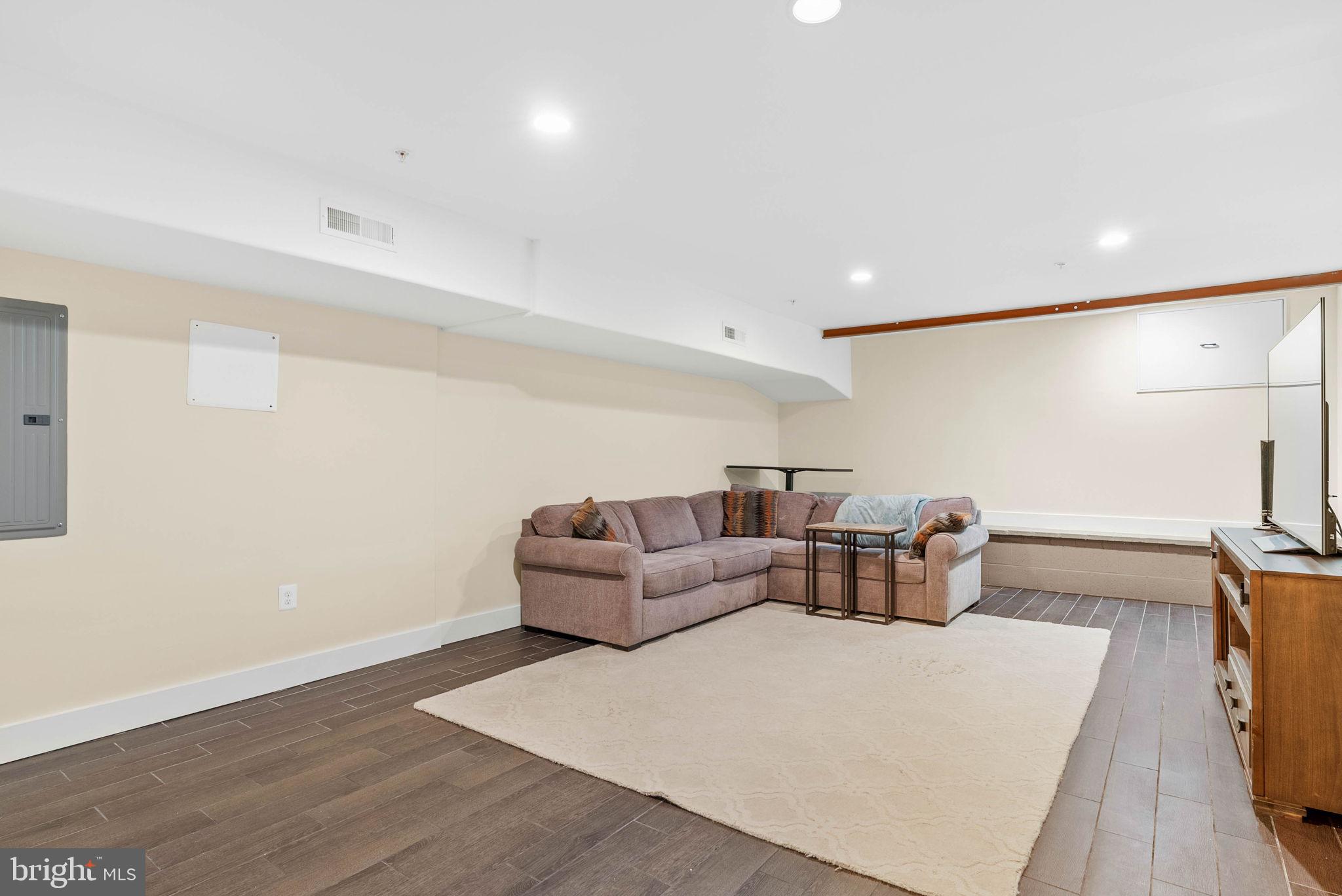 924 South 11th Street, Unit 101 Philadelphia, PA 19147 - Photo 20 of 27 a living room with furniture and a flat screen tv