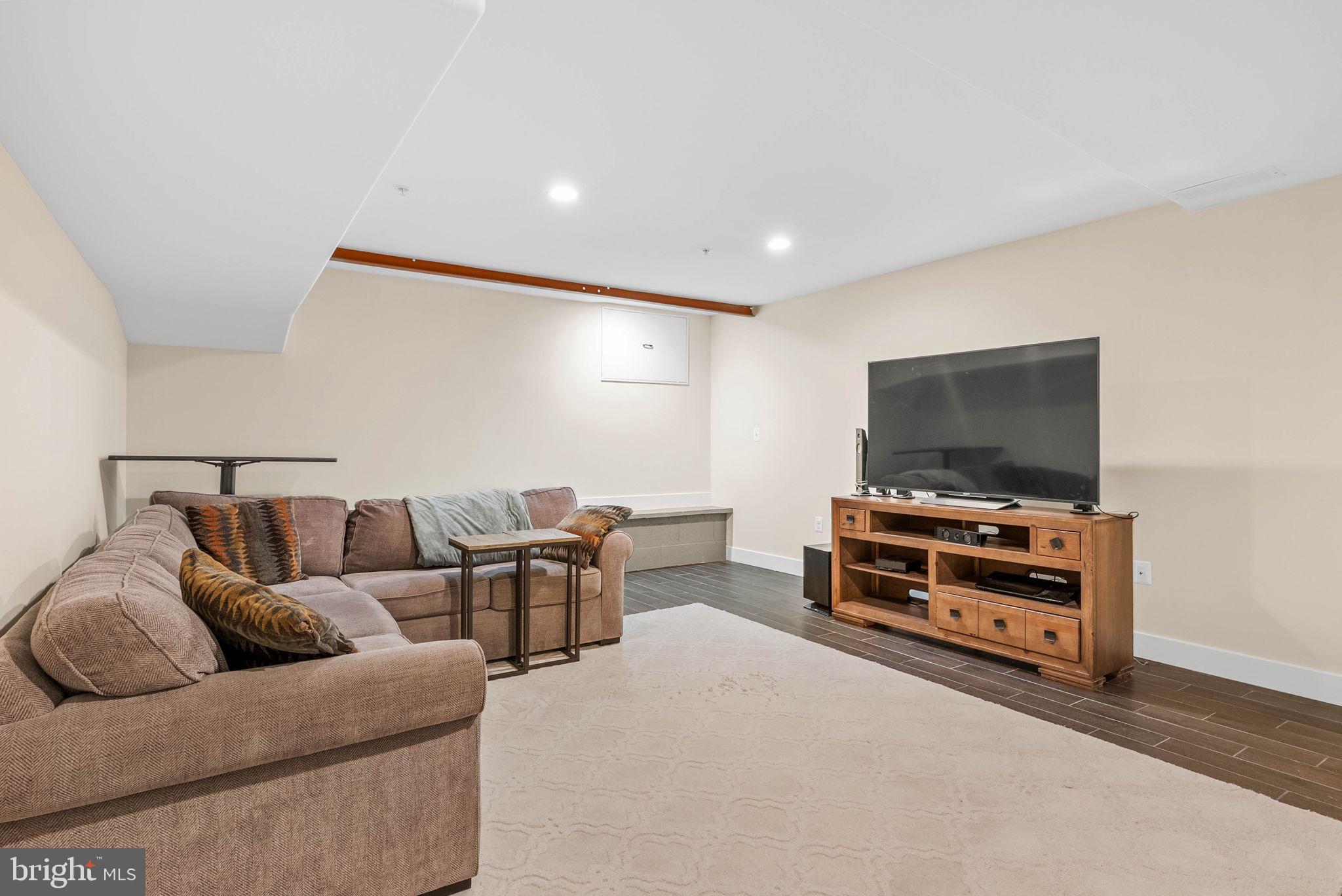 924 South 11th Street, Unit 101 Philadelphia, PA 19147 - Photo 21 of 27 a living room with furniture and a flat screen tv