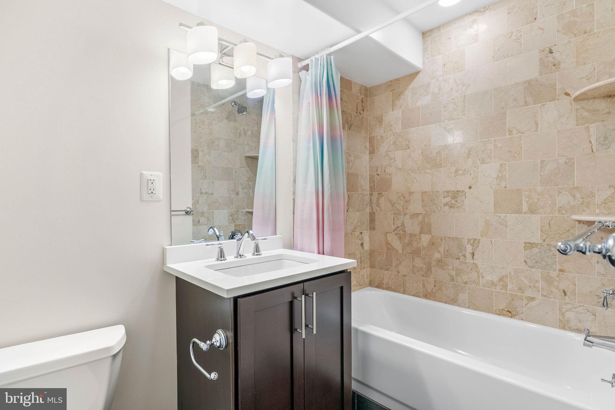 924 South 11th Street, Unit 101 Philadelphia, PA 19147 - Photo 23 of 27 a bathroom with a sink a toilet and shower