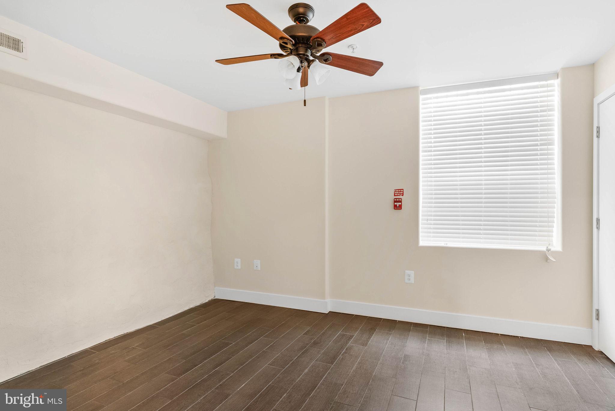 924 South 11th Street, Unit 101 Philadelphia, PA 19147 - Photo 24 of 27 wooden floor in an empty room with a window