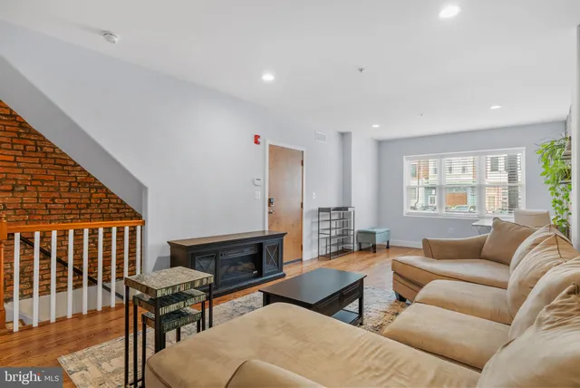 a living room with furniture wooden floor and a fireplace