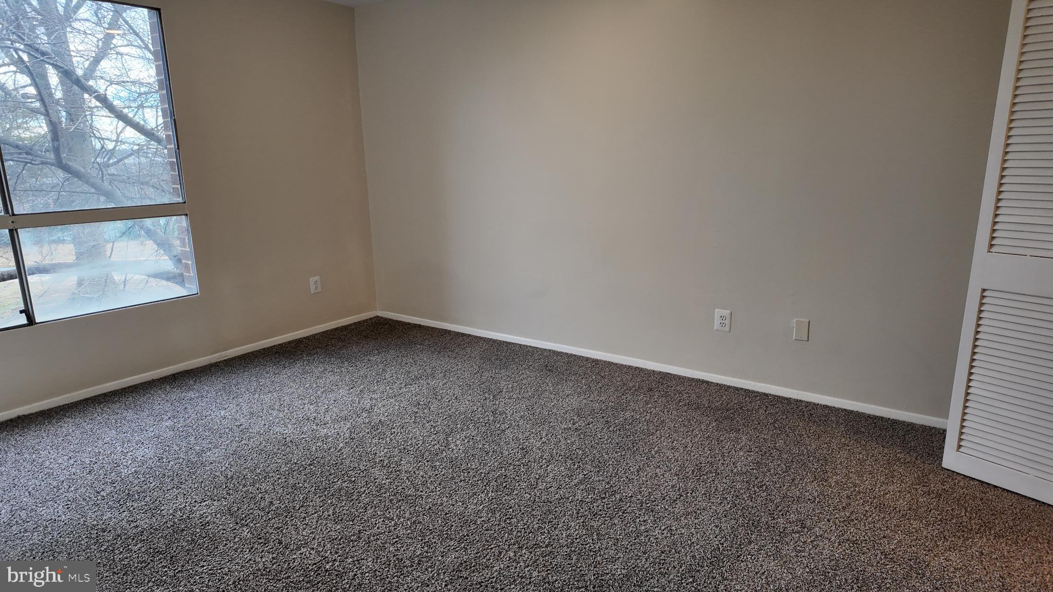 7957 Riggs Road, Unit 7 Hyattsville, MD 20783 - Photo 3 of 9 an empty room with a window