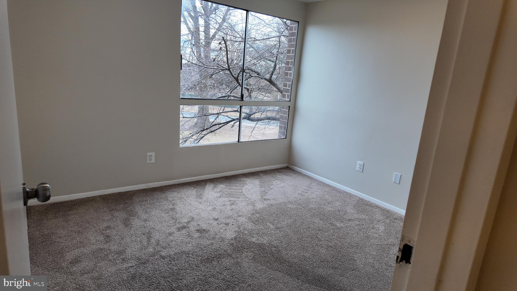7957 Riggs Road, Unit 7 Hyattsville, MD 20783 - Photo 6 of 9 an empty room with windows