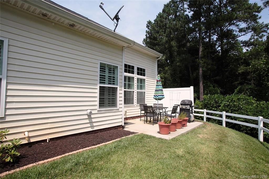 707 Prospect Lane, Unit 43 Fort Mill, SC 29708 - Photo 22 of 24 a view of a chair and tables in the back yard of the house