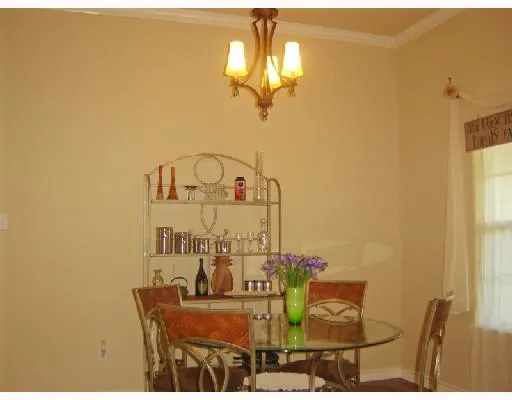 a view of a dining room with furniture and a chandelier