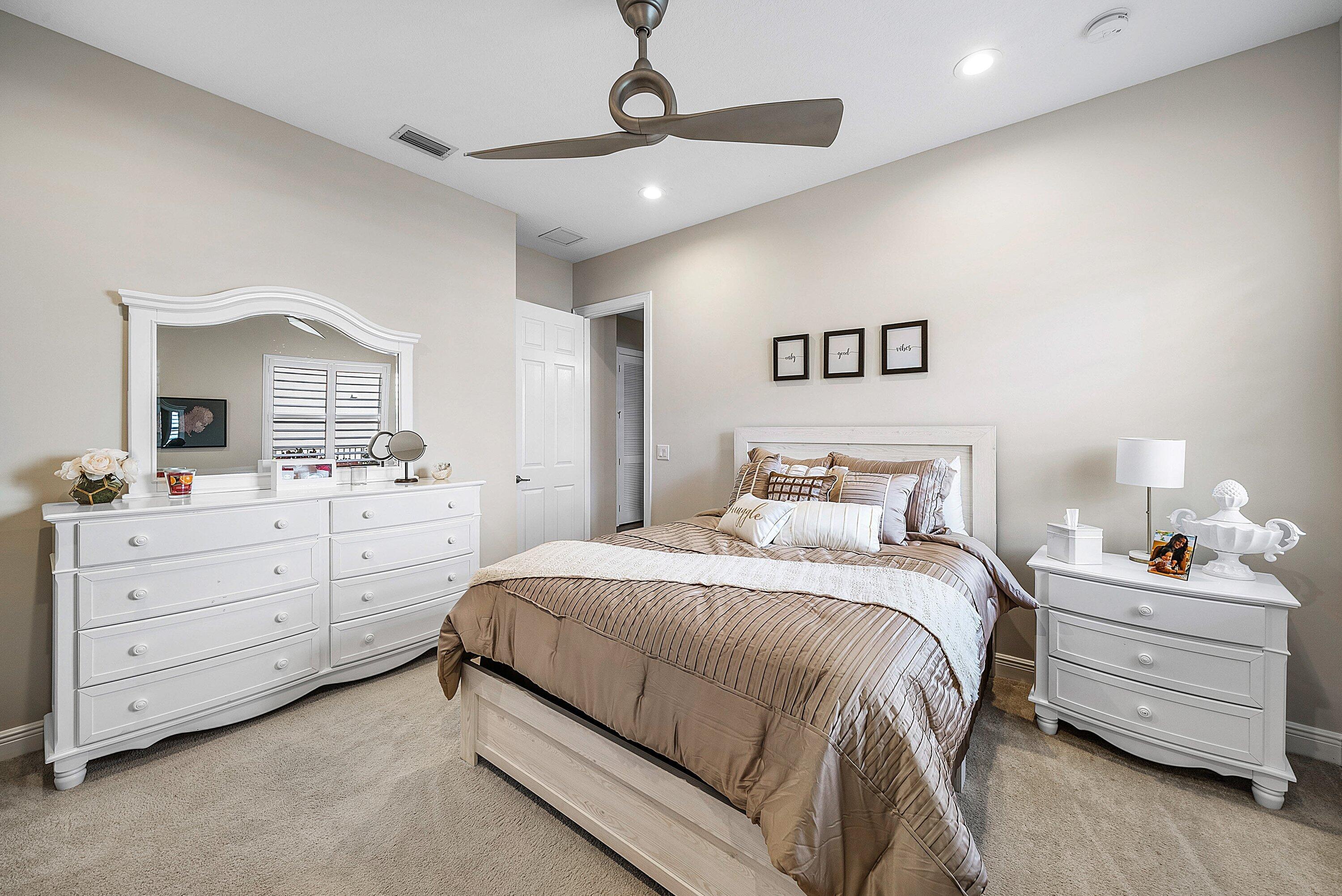 287 Rudder Cay Way Jupiter, FL 33458 - Photo 30 of 88 a bedroom with a bed and a dresser