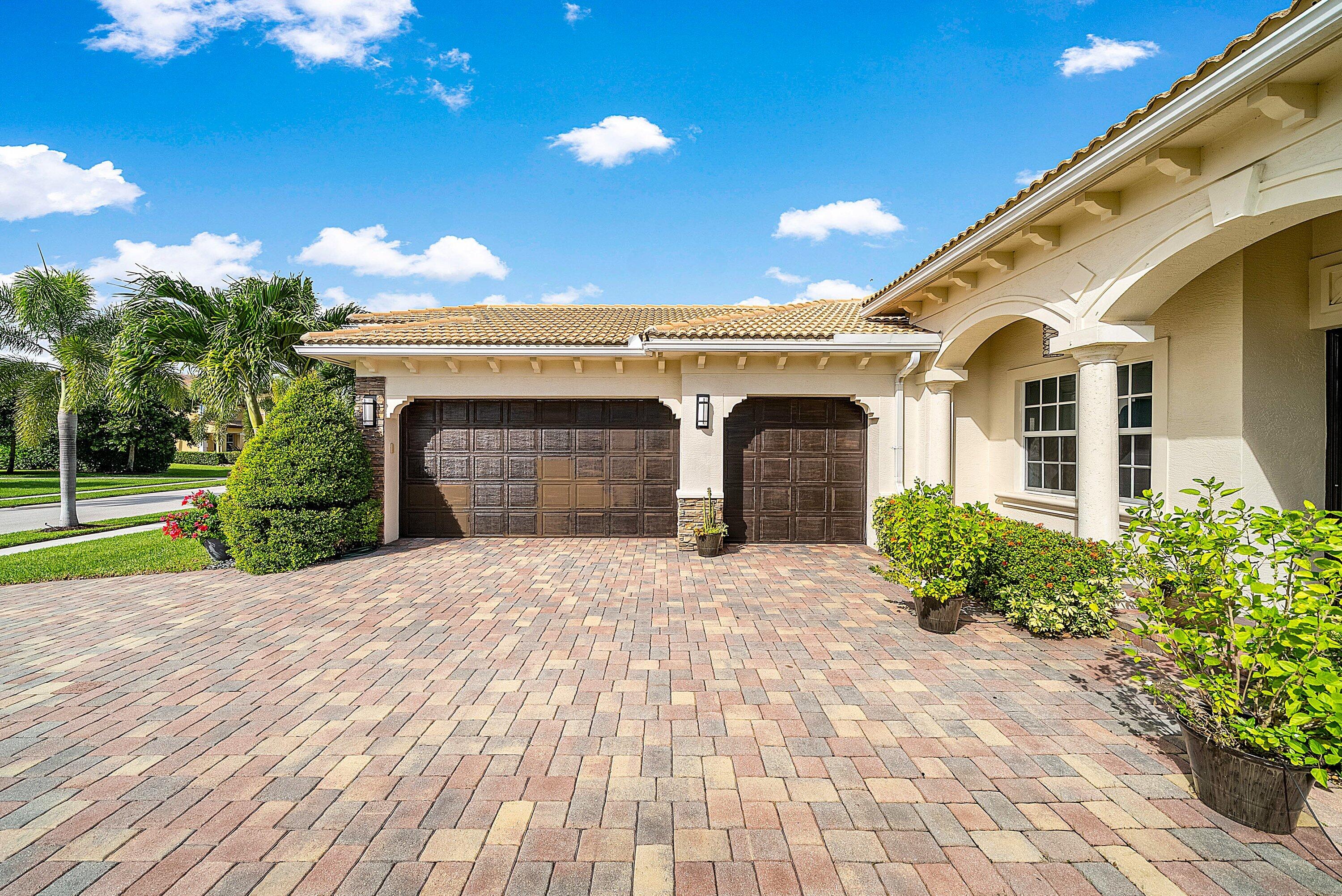 287 Rudder Cay Way Jupiter, FL 33458 - Photo 4 of 88 a front view of a house with a yard and garage