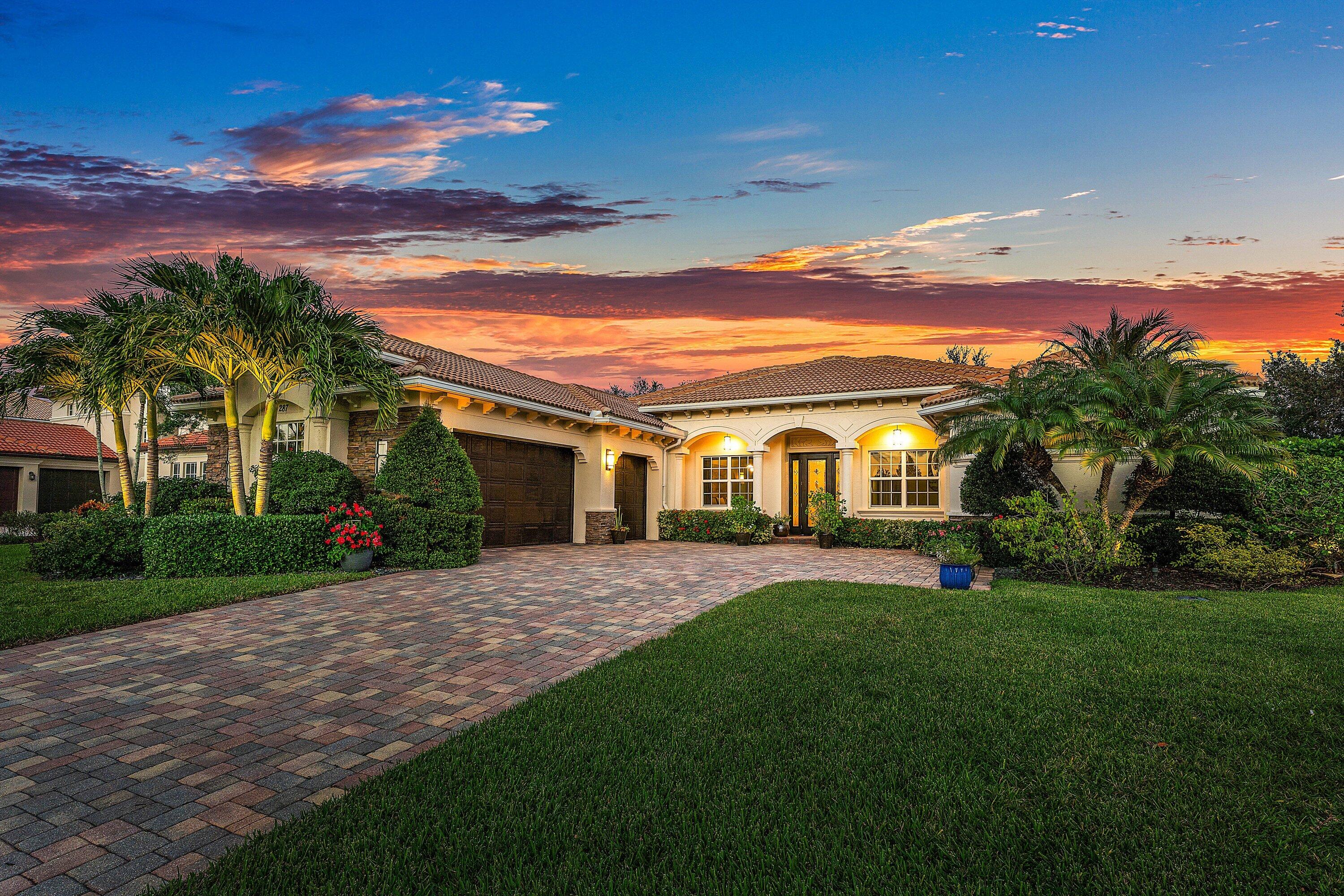 287 Rudder Cay Way Jupiter, FL 33458 - Photo 69 of 88 a front view of a house with a garden and yard