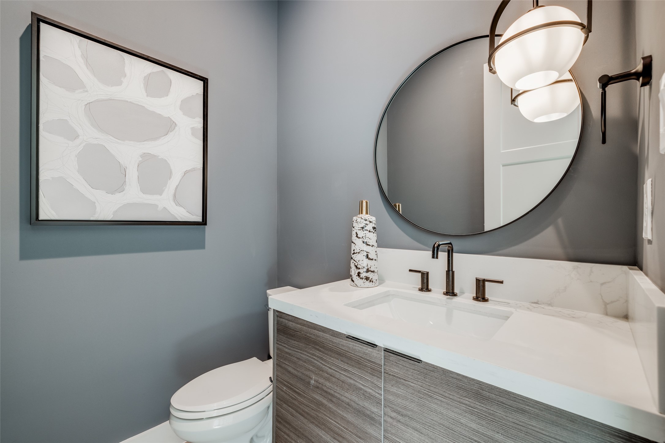 1306 Crocker Street Houston, TX 77019 - Photo 14 of 48 a bathroom with a toilet sink vanity and mirror