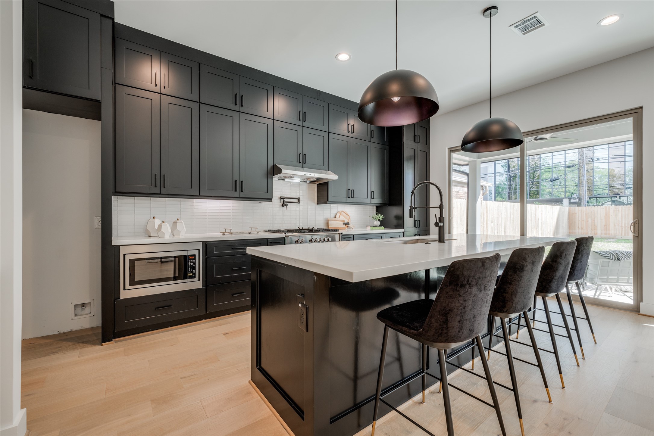 1306 Crocker Street Houston, TX 77019 - Photo 24 of 48 a kitchen with stainless steel appliances granite countertop a stove a refrigerator a kitchen island a sink cabinets and a dining table