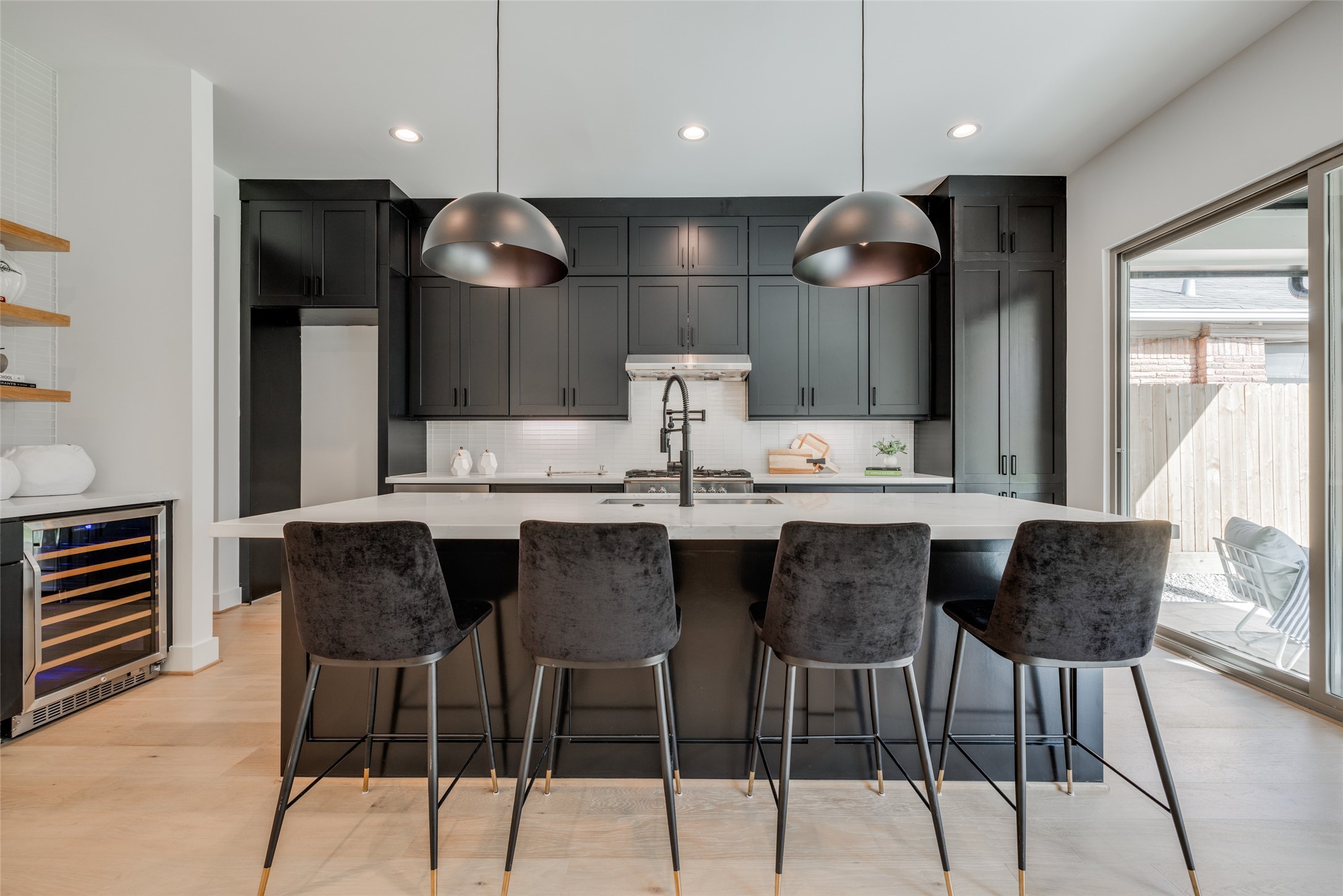 1306 Crocker Street Houston, TX 77019 - Photo 25 of 48 a kitchen with granite countertop a table chairs stove and wooden floor