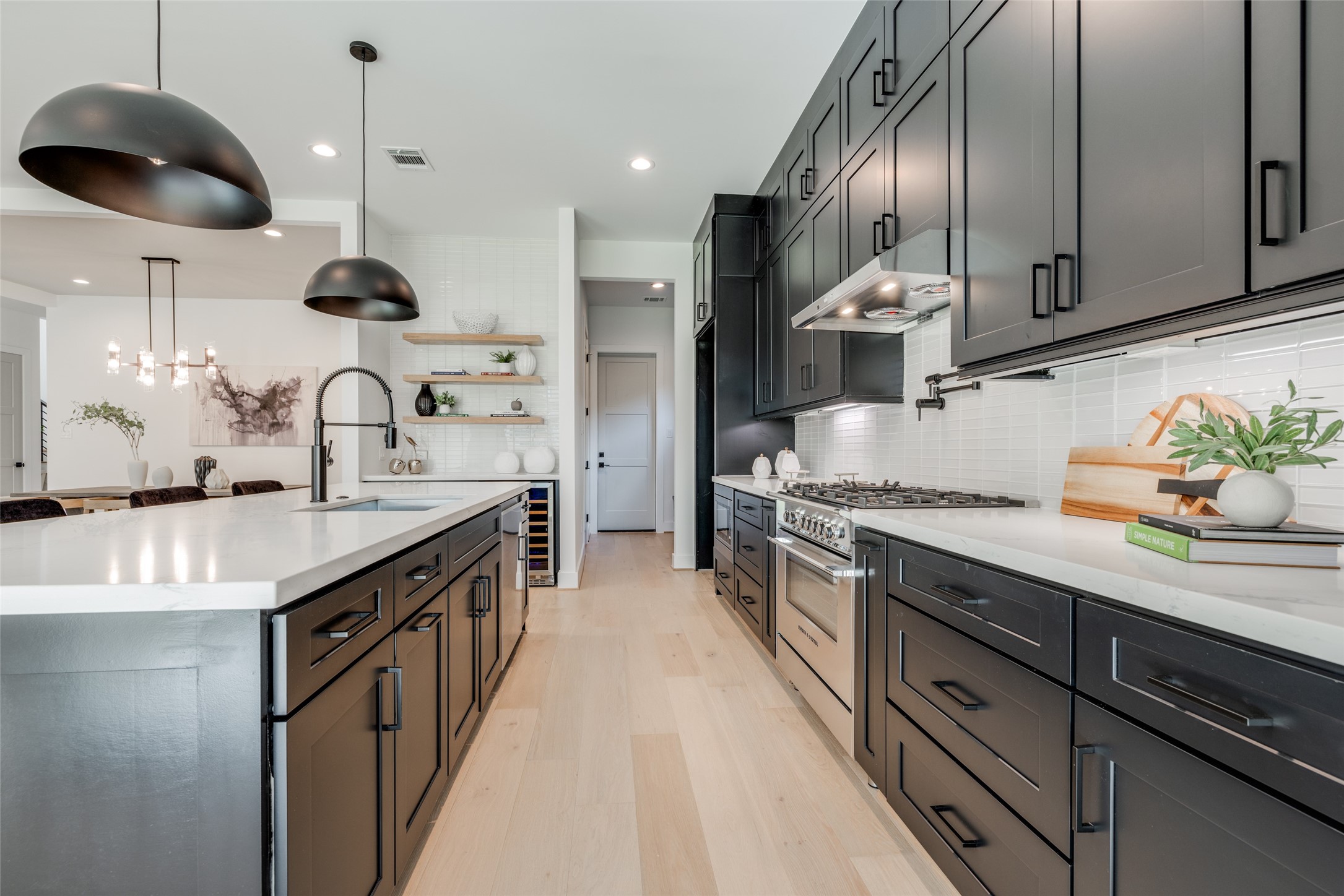 1306 Crocker Street Houston, TX 77019 - Photo 27 of 48 a kitchen with stainless steel appliances granite countertop a sink a stove and a wooden floors