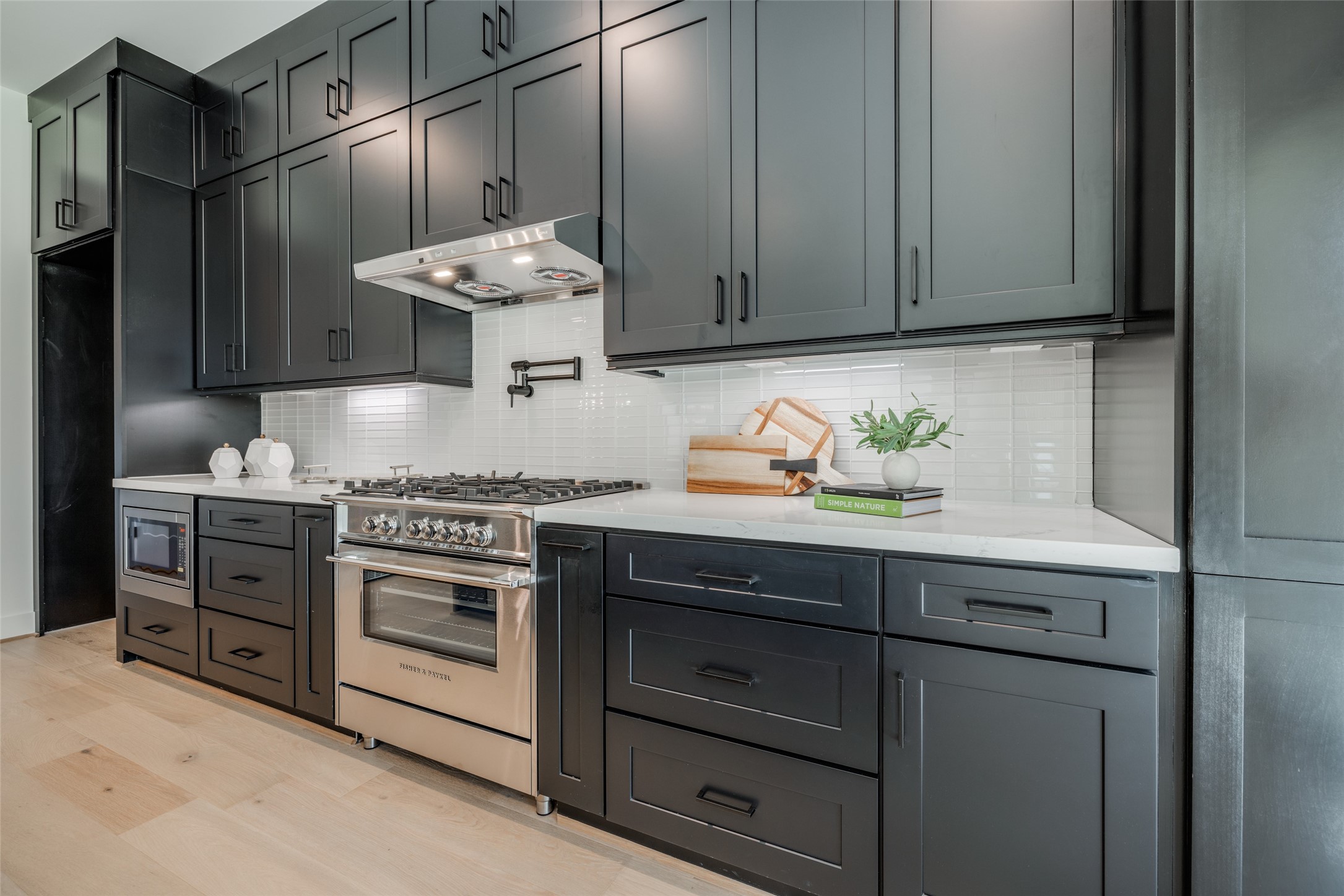 1306 Crocker Street Houston, TX 77019 - Photo 28 of 48 a kitchen with stainless steel appliances a stove and cabinets