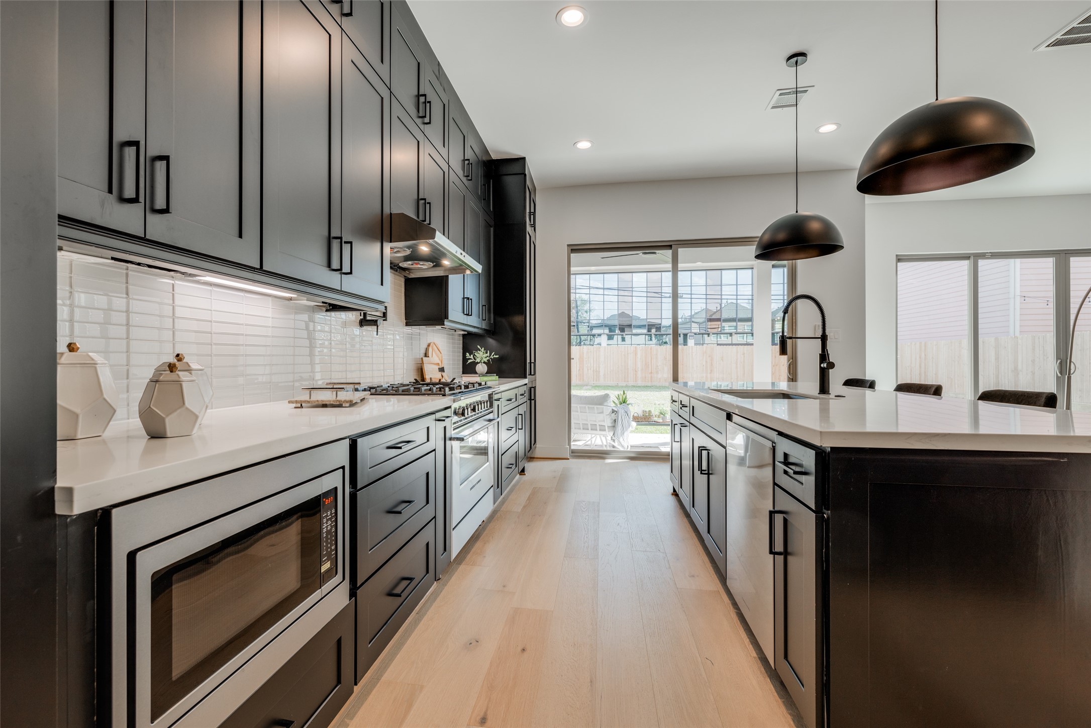 1306 Crocker Street Houston, TX 77019 - Photo 30 of 48 a kitchen with stainless steel appliances granite countertop a sink a stove and a wooden floors