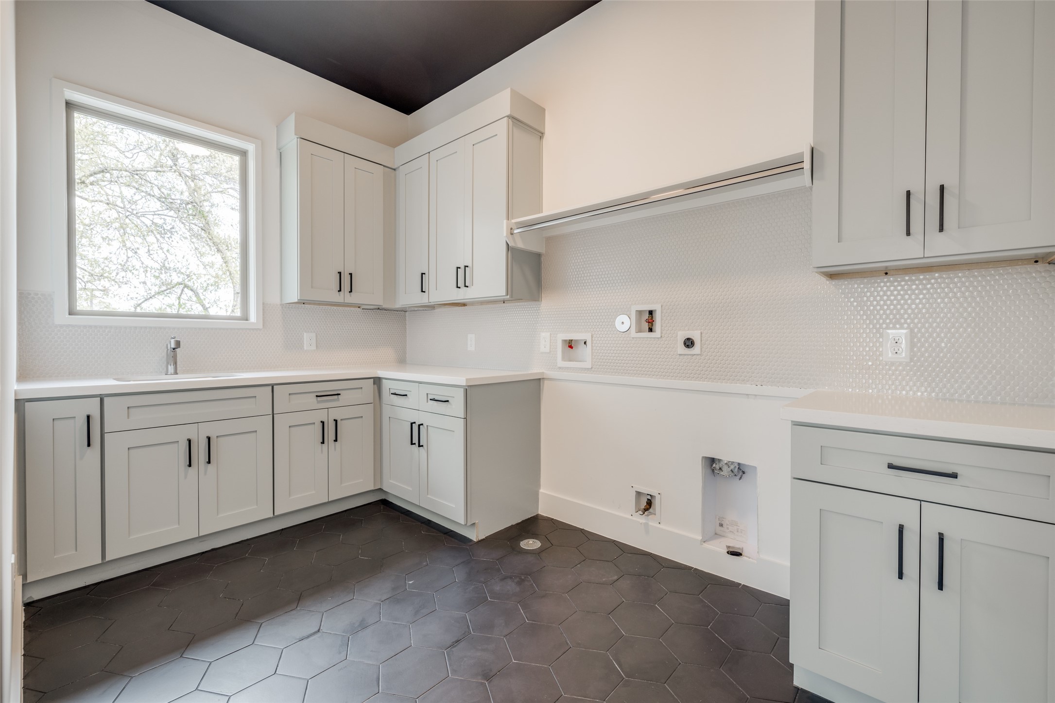 1306 Crocker Street Houston, TX 77019 - Photo 45 of 48 a kitchen with white cabinets and white appliances