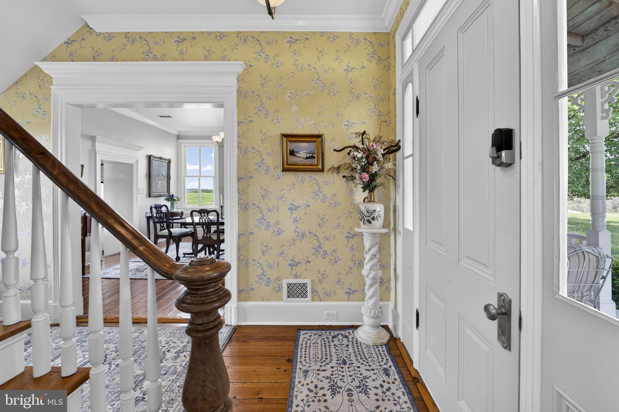 9078 Maidstone Road Delaplane, VA 20144 - Photo 12 of 36 a view of a hallway with wooden floor and staircase
