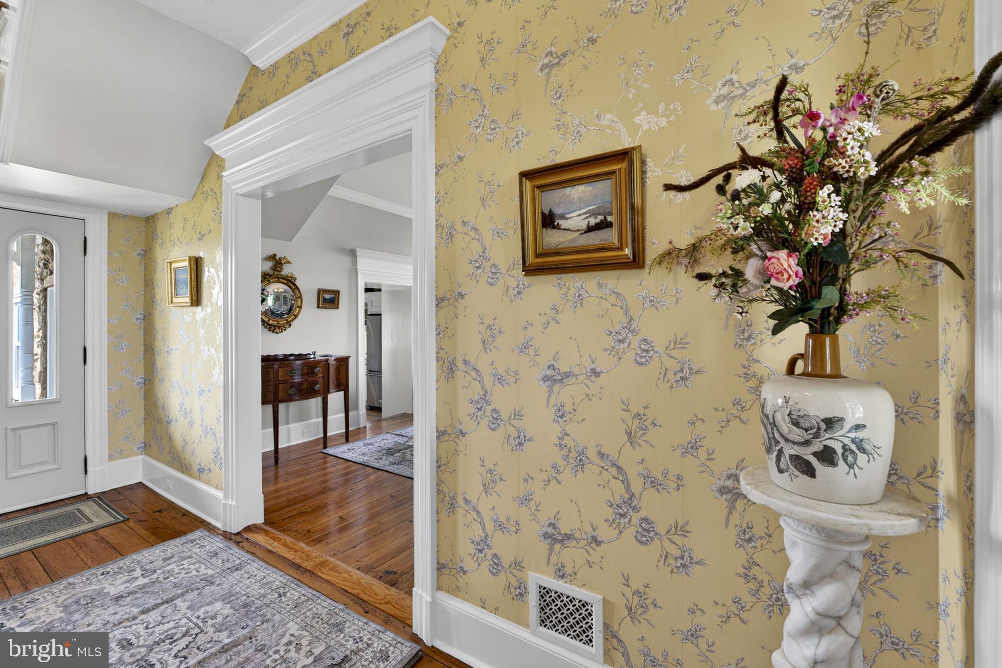 9078 Maidstone Road Delaplane, VA 20144 - Photo 14 of 36 a view of a hallway with wooden floor and a potted plant