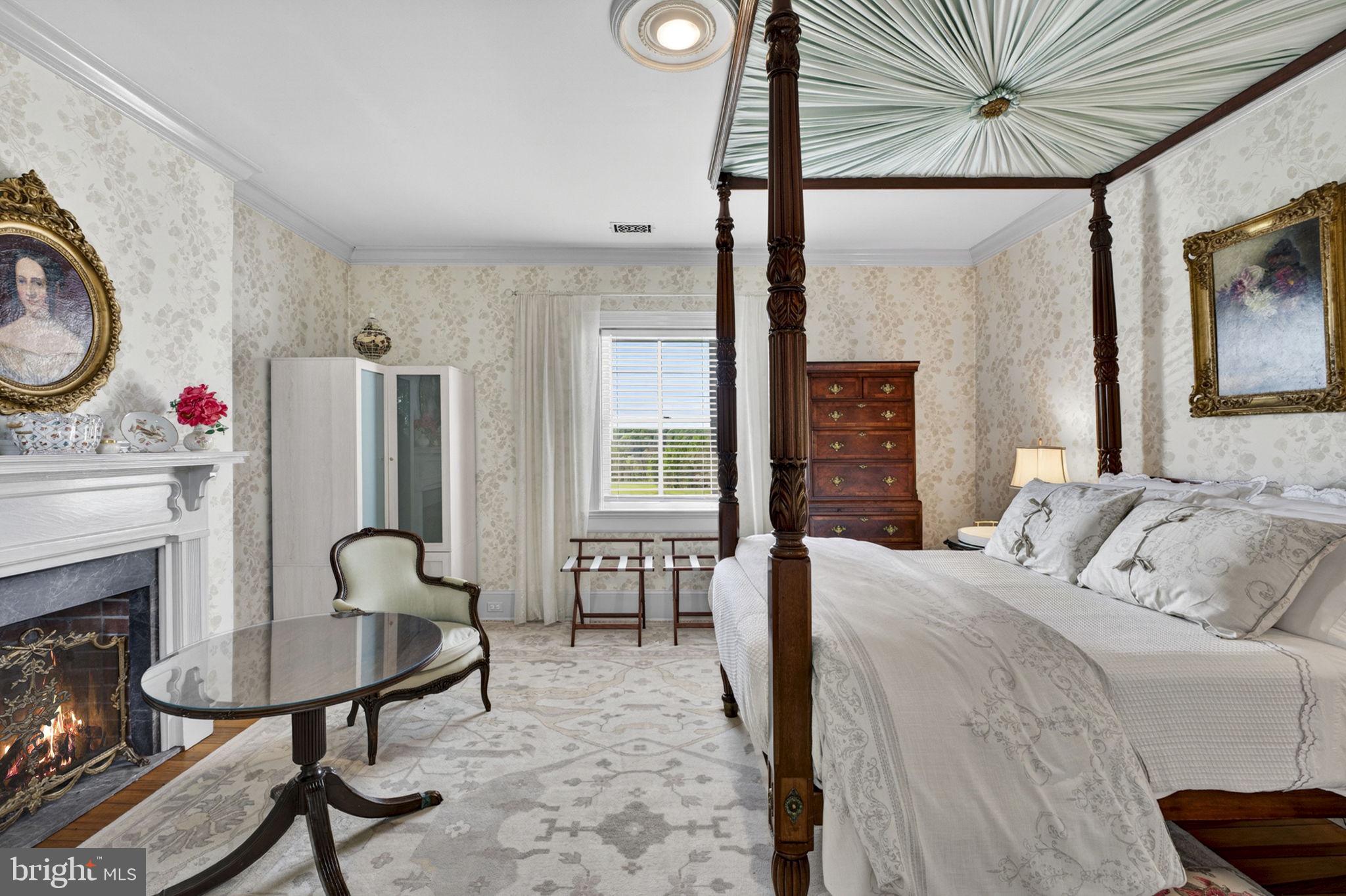 9078 Maidstone Road Delaplane, VA 20144 - Photo 28 of 36 a bedroom with a bed a table and chair