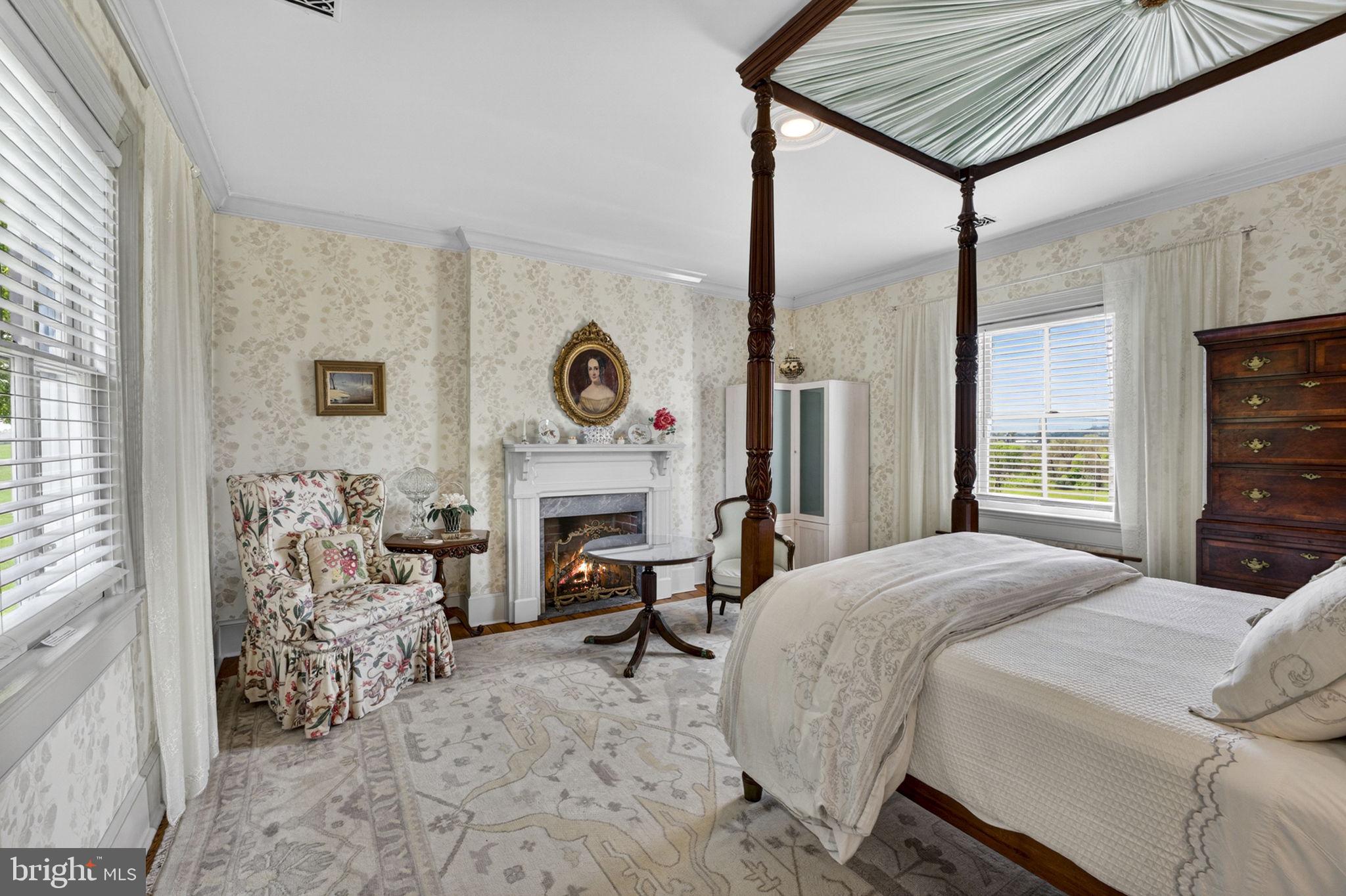 9078 Maidstone Road Delaplane, VA 20144 - Photo 29 of 36 a bedroom with a bed and a fireplace