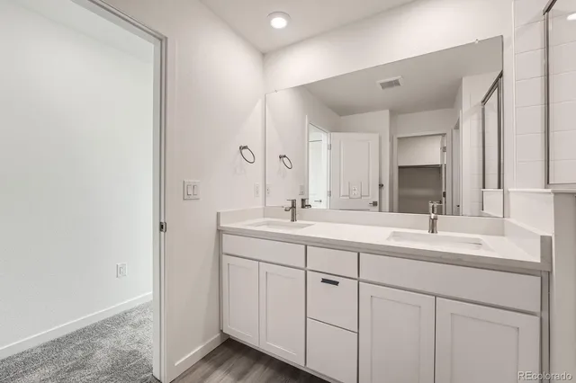 a bathroom with 2 sink and a mirror