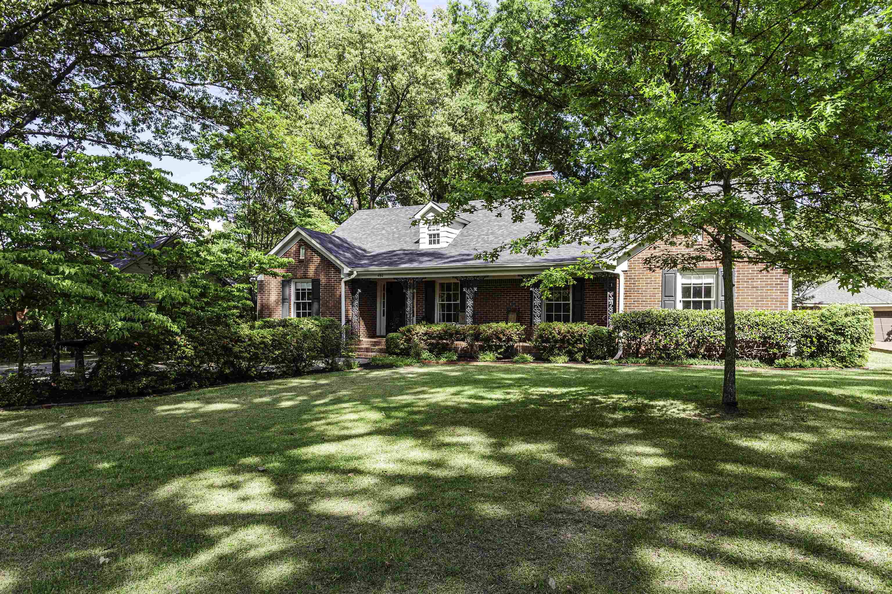 Brick exterior with a covered front porch featuring decorative columns