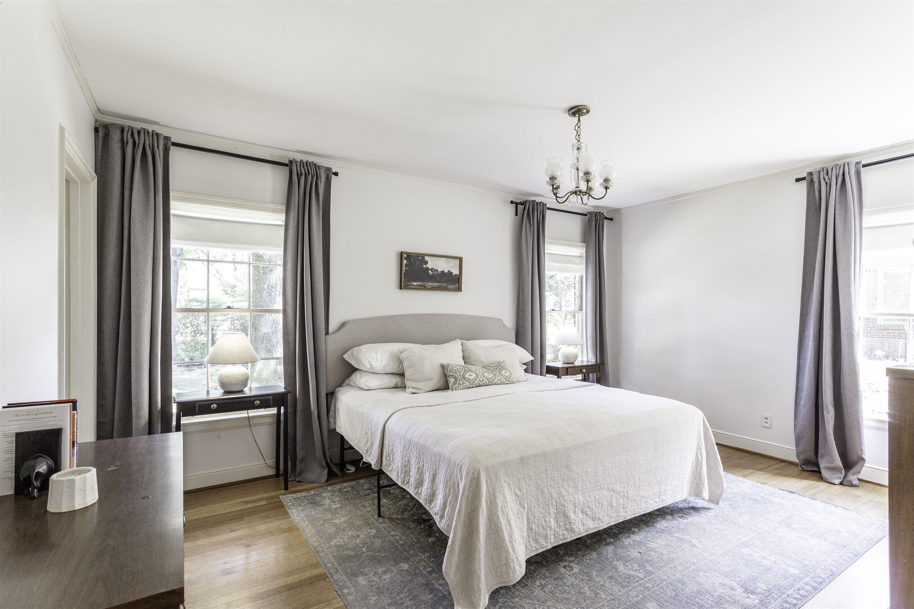 480 Colonial Road Memphis, TN 38117 - Photo 8 of 16 Spacious room featuring hardwood flooring, multiple windows providing ample natural light, a chandelier-style light fixture, and white wall finishes