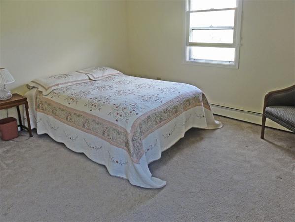 225 Stow Road Harvard, MA 01451 - Photo 13 of 24 a bed sitting in a bedroom next to a window