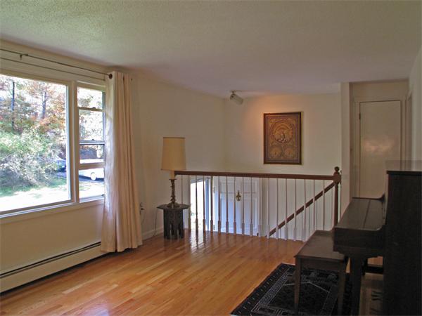 225 Stow Road Harvard, MA 01451 - Photo 3 of 24 a view of a hallway with wooden floor and stairs