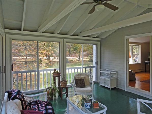 225 Stow Road Harvard, MA 01451 - Photo 9 of 24 a living room with furniture and a floor to ceiling window