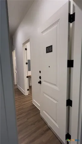 a view of a room with wooden floor and window