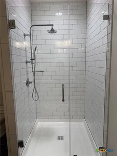a bathroom with a double vanity sink and mirror