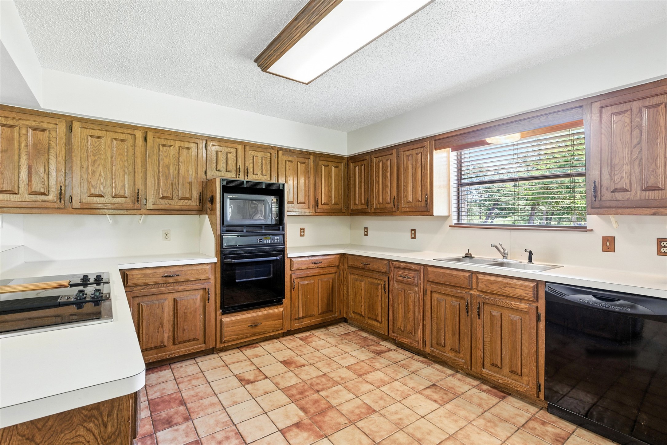 1680 Bowler Road Waller, TX 77484 - Photo 15 of 42 a kitchen with stainless steel appliances granite countertop a stove sink and cabinets