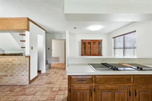 a living room with stainless steel appliances granite countertop furniture and a fireplace