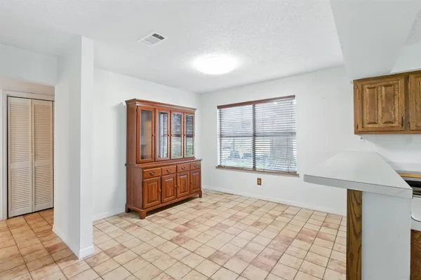 a large bedroom with a bed and glass windows