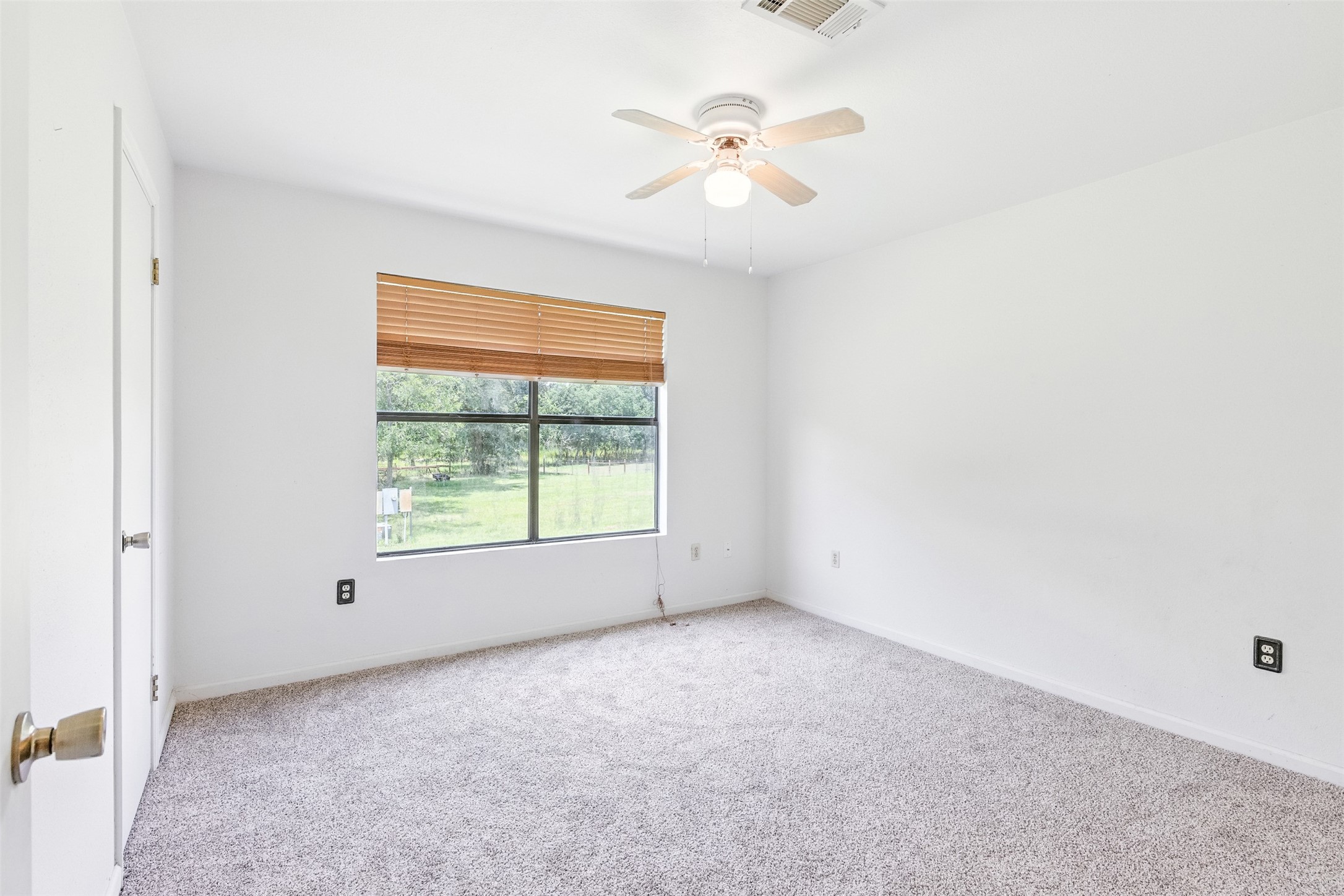 1680 Bowler Road Waller, TX 77484 - Photo 29 of 42 an empty room with a window and a fan